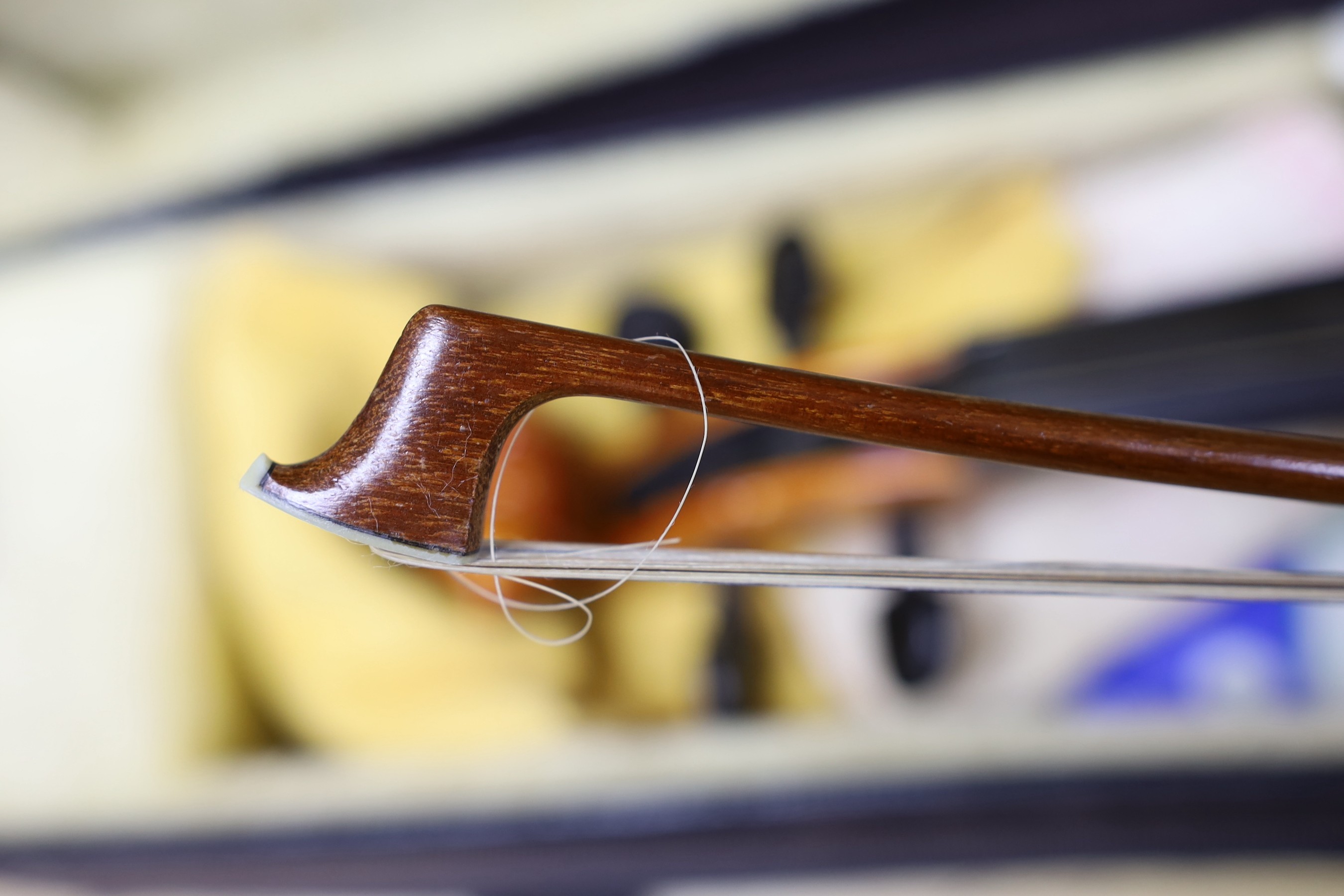 A cased viola crackled glaze, with bow